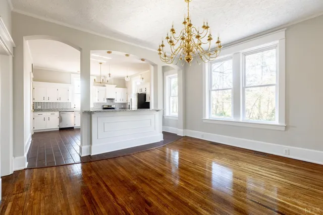 a view of a livingroom with wooden floor and a fireplace