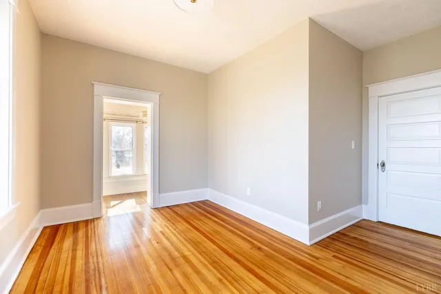 a view of a room with wooden floor and brick walls