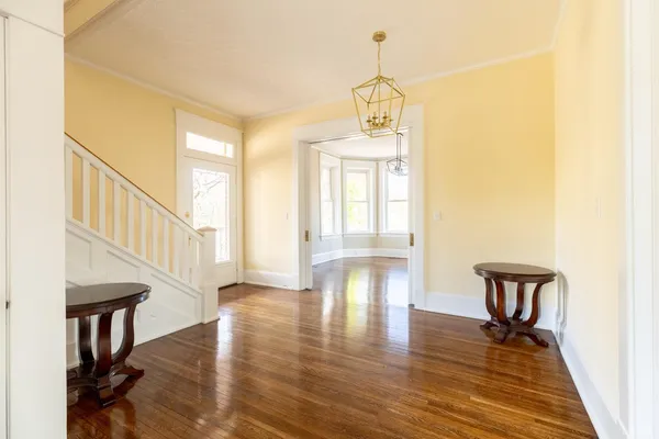 a view of an entryway with wooden floor