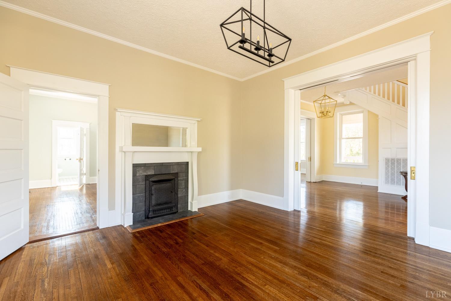 211 Cook Avenue Brookneal, VA 24528 - Photo 6 of 50 a view of empty room with wooden floor and fireplace