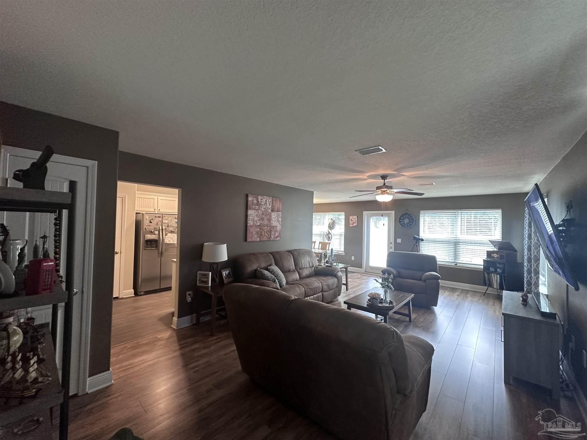 5217 Saufley Field Road Pensacola, FL 32526 - Photo 2 of 26 a living room with furniture window and wooden floor