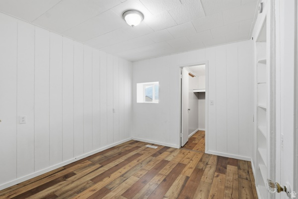 25615 Main Street Portage, UT 84331 - Photo 19 of 42 Unfurnished bedroom featuring hardwood / wood-style flooring and a walk in closet