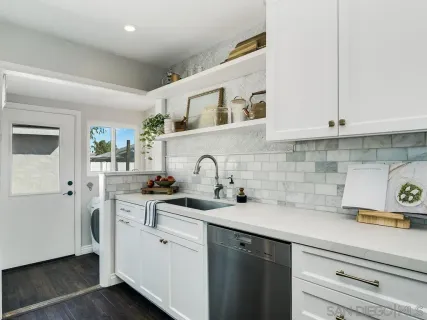 a kitchen with stainless steel appliances granite countertop a sink a stove and cabinets