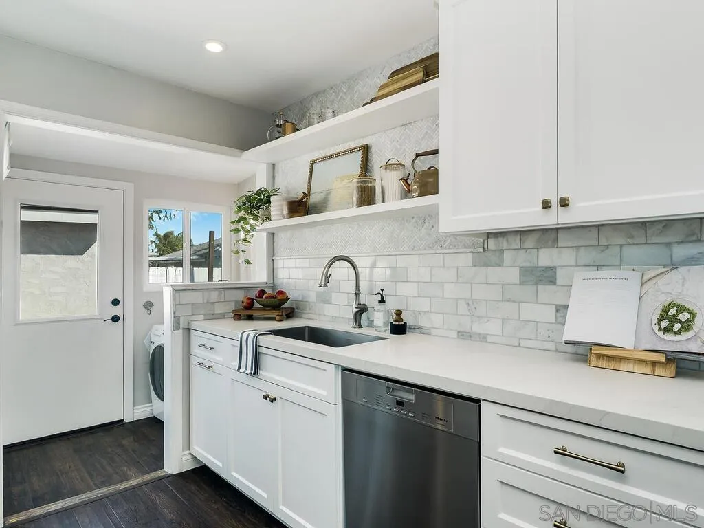 4751 Altadena Avenue San Diego, CA 92115 - Photo 13 of 47 a kitchen with stainless steel appliances granite countertop a sink a stove and cabinets