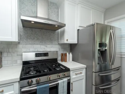 a kitchen with refrigerator and cabinets