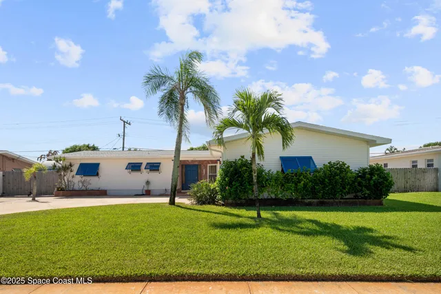a house view with swimming pool and garden