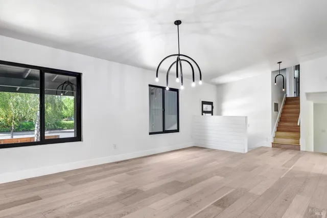 an empty room with a window and a ceiling fan
