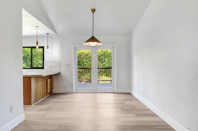 a view of an empty room with a fireplace and a window