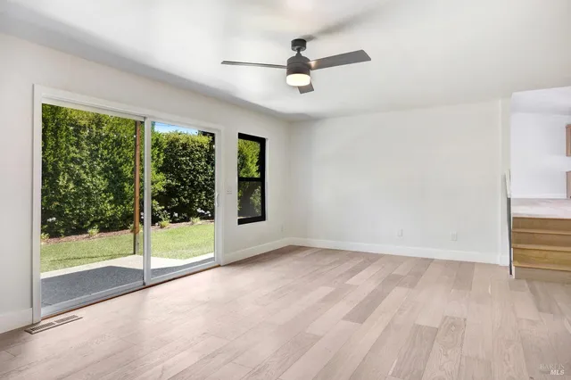 a living room with furniture a rug and a window