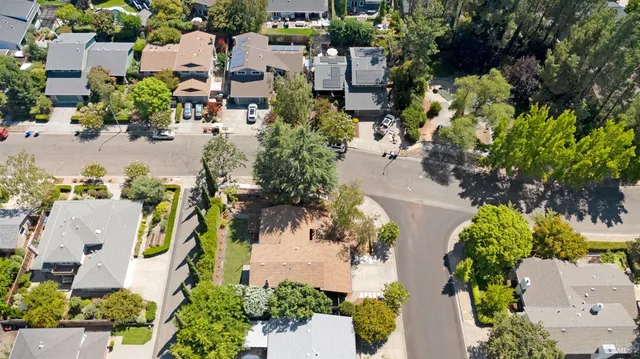 a kitchen with granite countertop white cabinets and stainless steel appliances