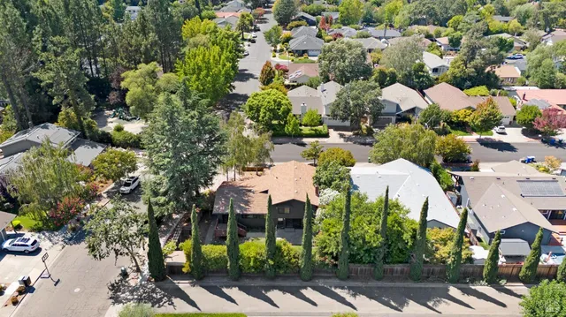 a dining room with furniture a chandelier and window