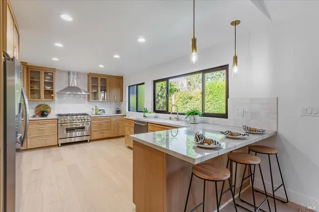 a bathroom with a granite countertop sink a potted plant and a mirror