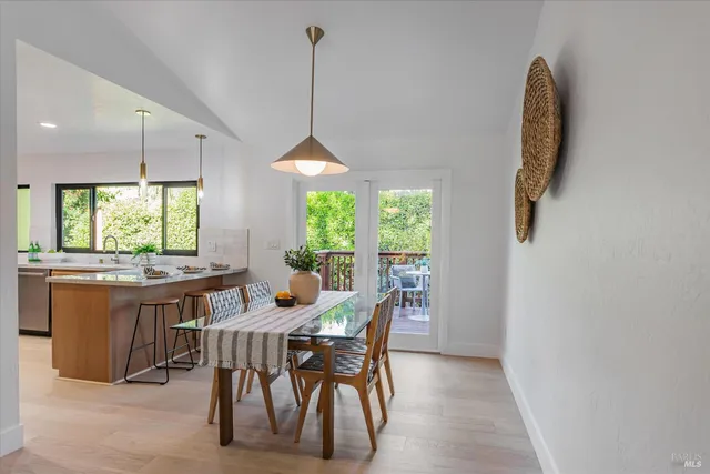 a view of a chairs and table in backyard of the house