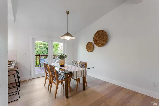 a view of a backyard with a swing table and chairs