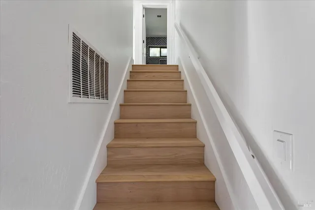 a view of a chair and table in backyard of the house