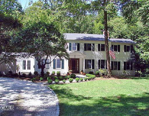 34 Indian Hill Road Wilton, CT 06897 - Photo 1 of 1 a front view of a house with garden and trees