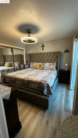 a bedroom with a bed and wooden floor
