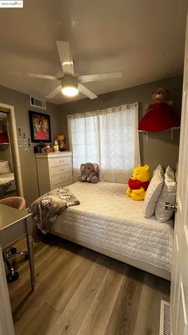 a bedroom with a bed and a tv on table