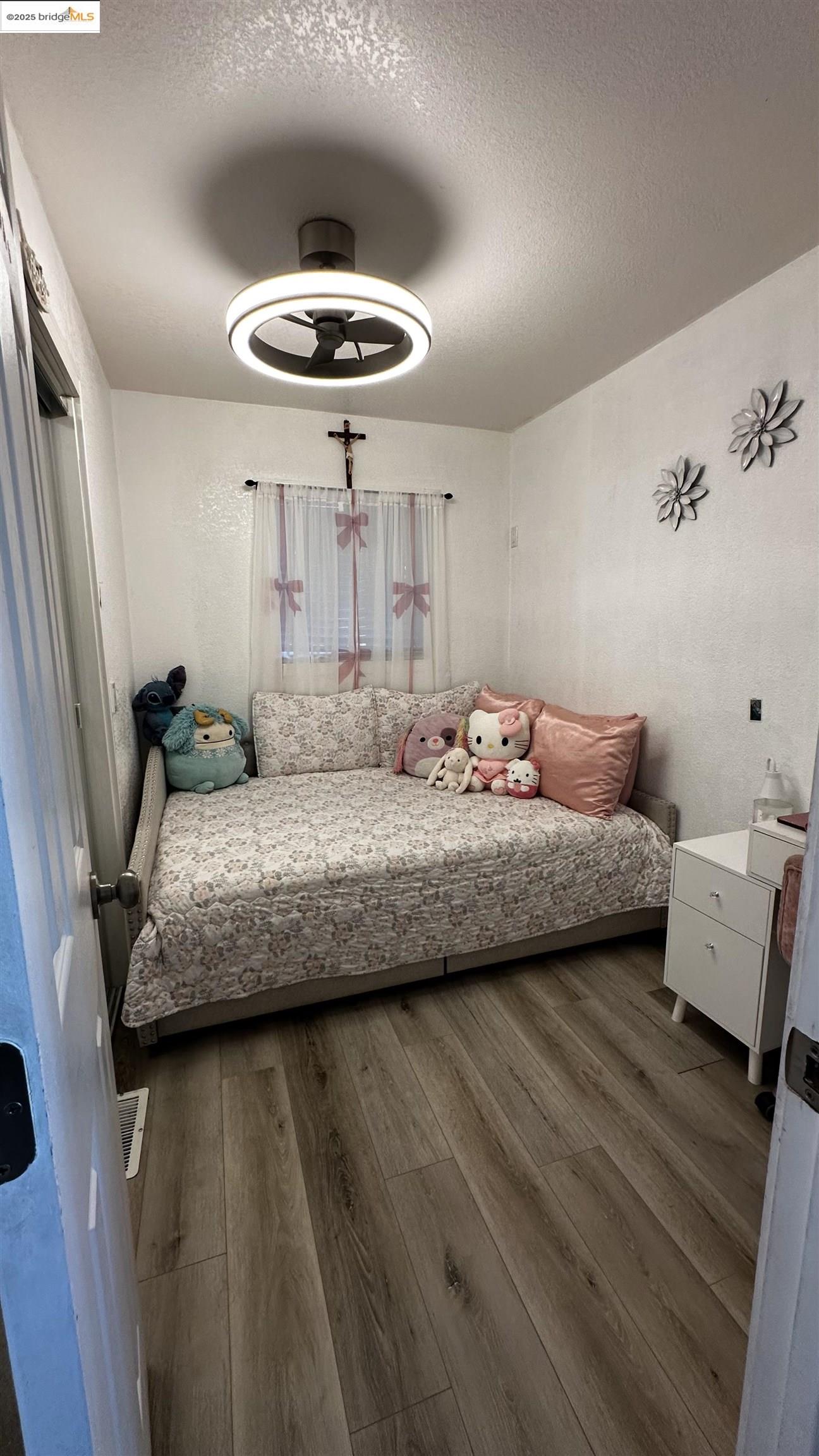 3301 Buchanan Road, Unit 89 Antioch, CA 94509 - Photo 18 of 22 a bedroom with a bed and wooden floor