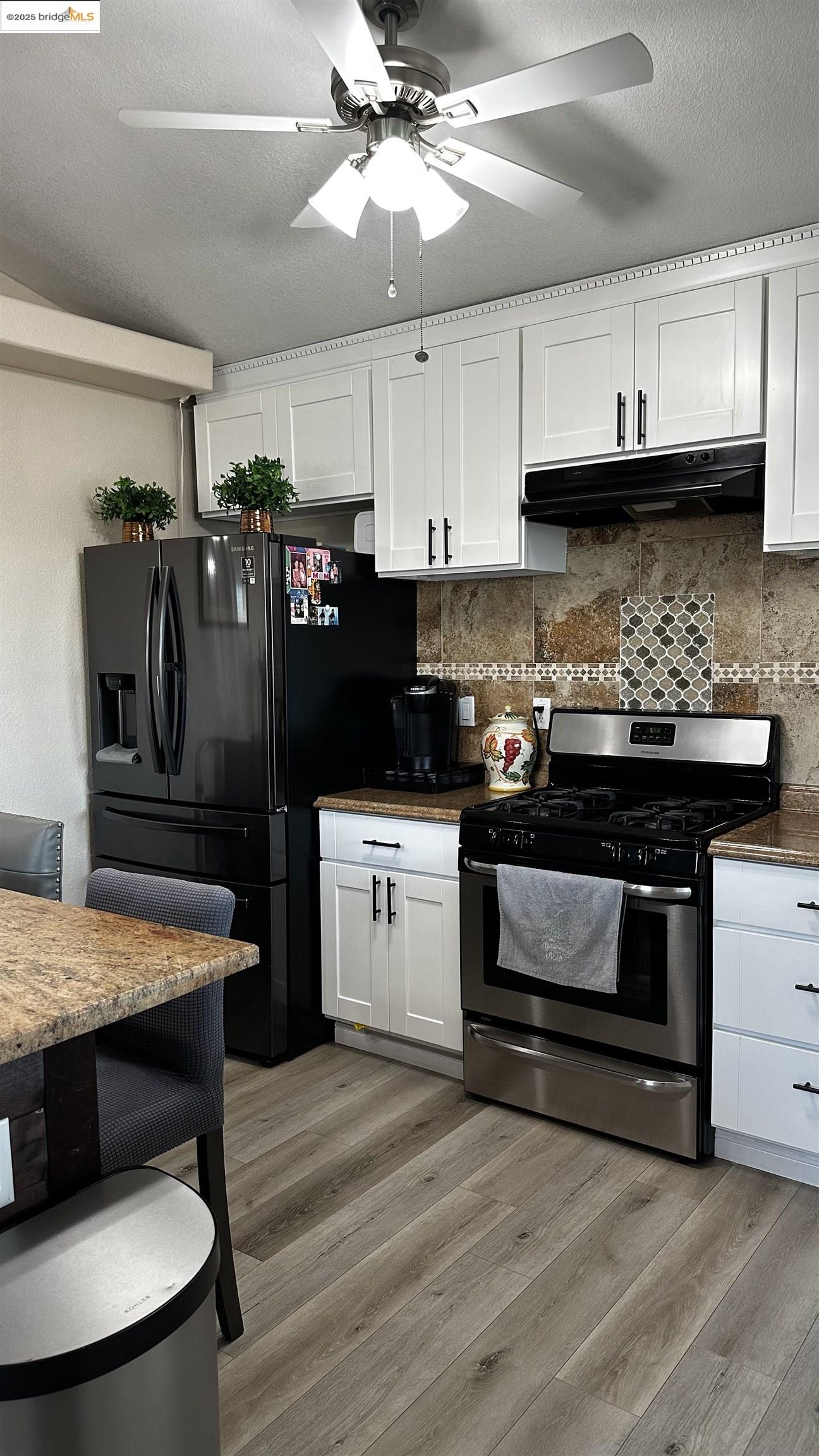 3301 Buchanan Road, Unit 89 Antioch, CA 94509 - Photo 7 of 22 a kitchen with stainless steel appliances granite countertop a stove a refrigerator and a microwave
