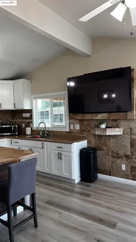 a kitchen with stainless steel appliances kitchen island granite countertop a stove a sink and a microwave