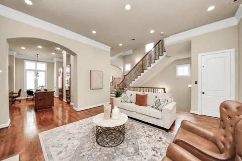 a living room with furniture and wooden floor