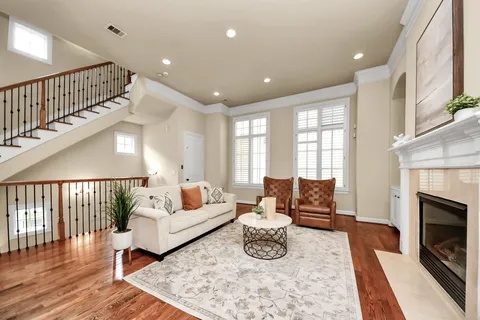 a living room with furniture fireplace and a table