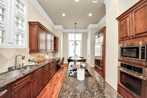 a kitchen with sink refrigerator and stove