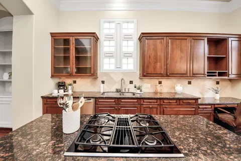 a kitchen with a stove a sink and a microwave
