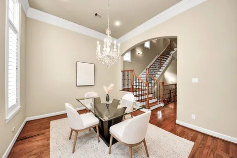a dining room with furniture and wooden floor