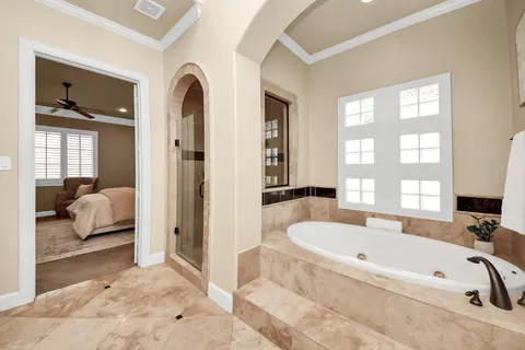 a bathroom with a tub and a large window