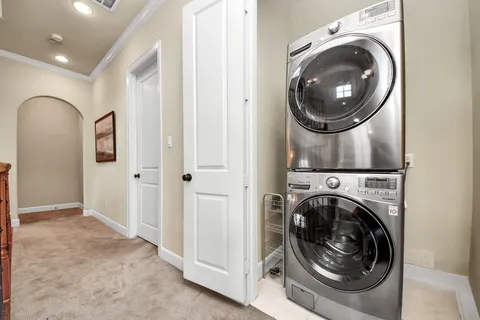a view of a hallway with washer and dryer