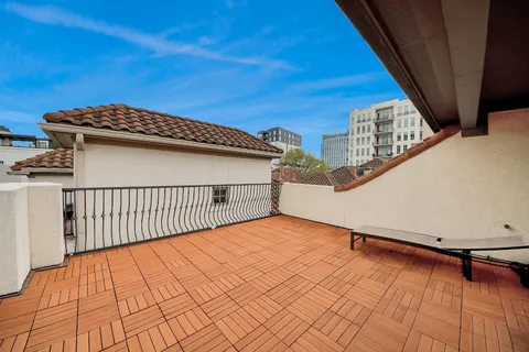a view of balcony with wooden floor