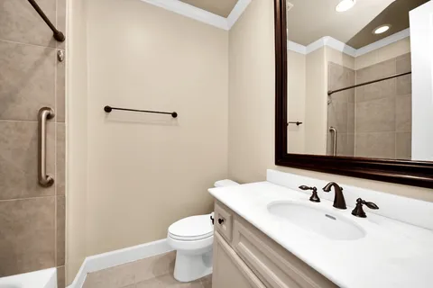 a bathroom with a sink toilet and shower