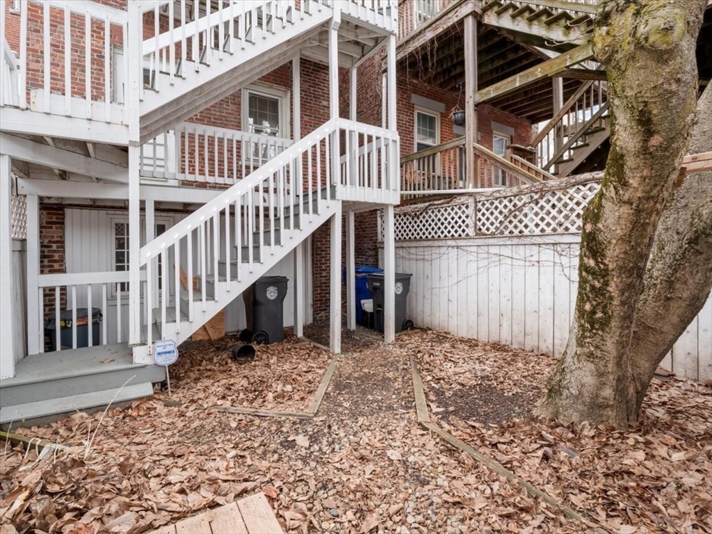 67 Broadway, Unit 1 Chelsea, MA 02150 - Photo 13 of 17 front view of a house with a wooden fence