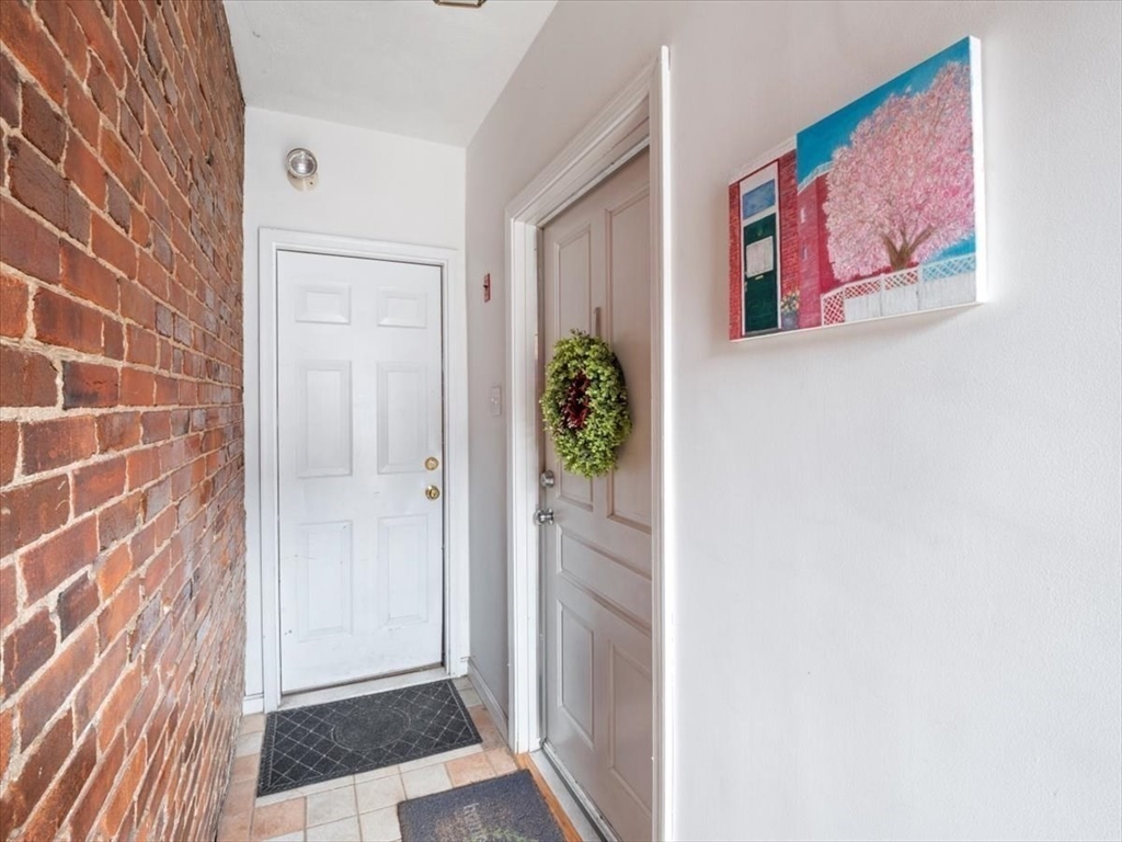 67 Broadway, Unit 1 Chelsea, MA 02150 - Photo 16 of 17 a view of a hallway with paintings on the wall
