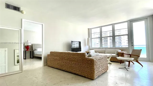 a bedroom with a bed and a couch next to a window