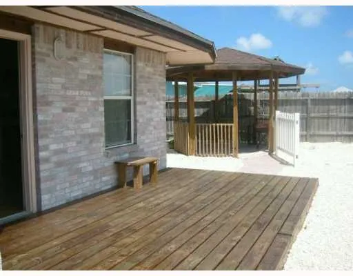 a view of a patio with a table and chairs