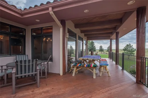 a view of a porch with furniture and yard