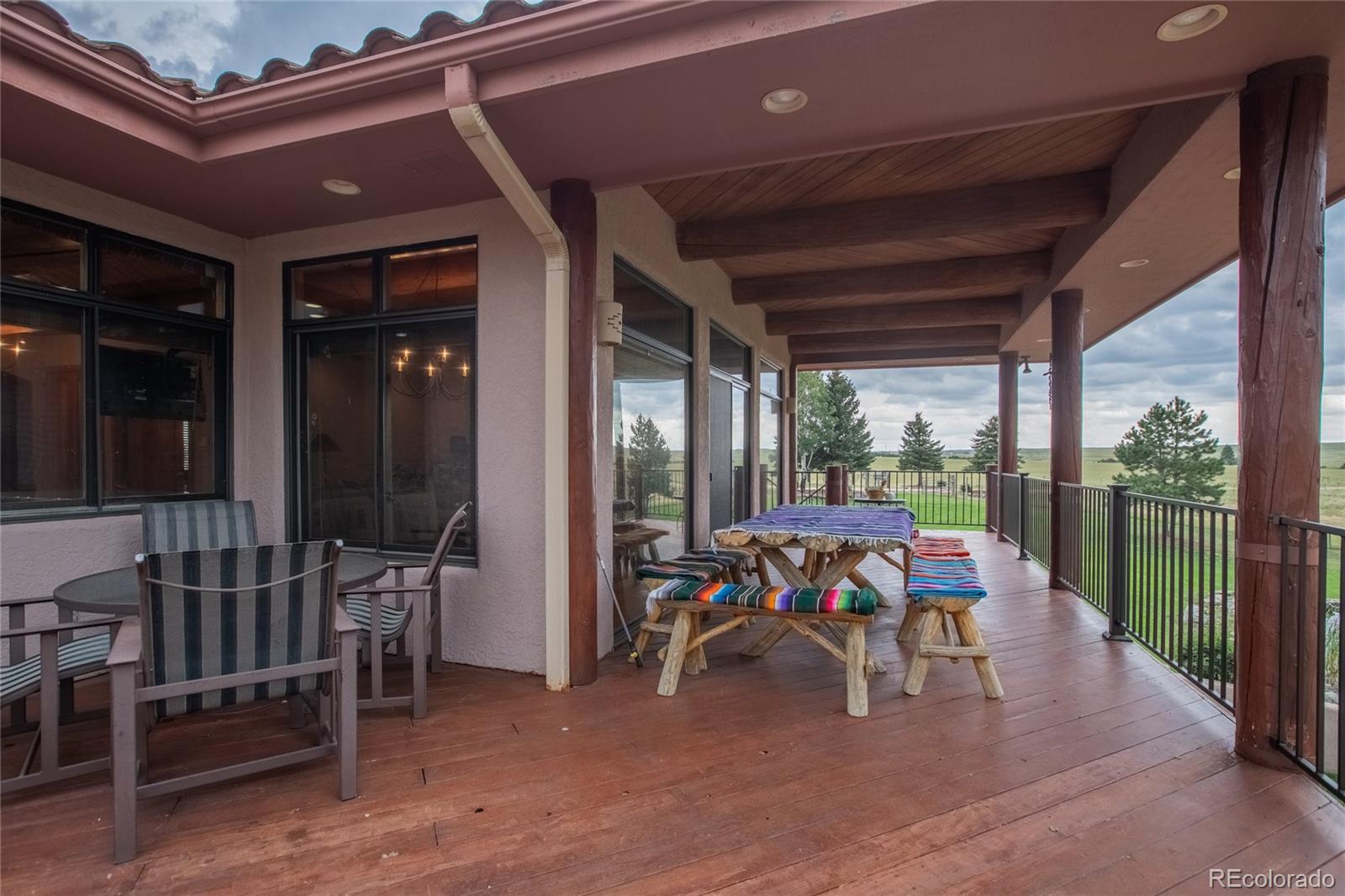 11503 East Smith Road Elbert, CO 80106 - Photo 14 of 44 a view of a porch with furniture and yard