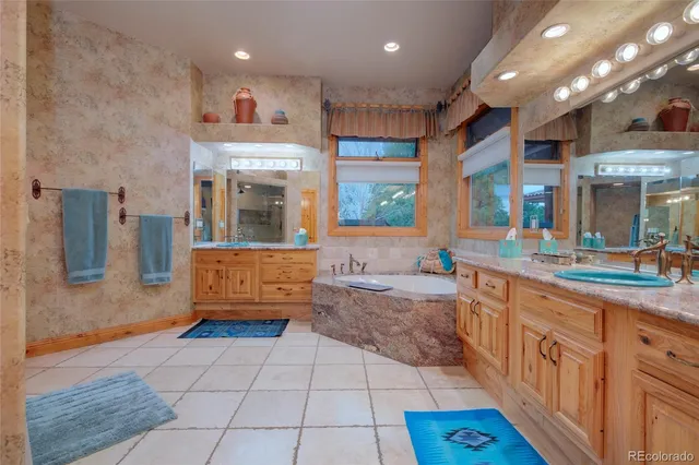 a large bathroom with a large tub and sink