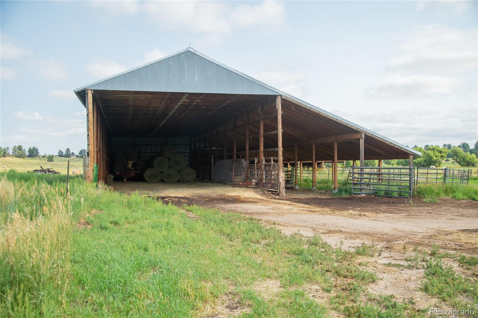 11503 East Smith Road Elbert, CO 80106 - Photo 21 of 44 a view of a house with backyard and porch