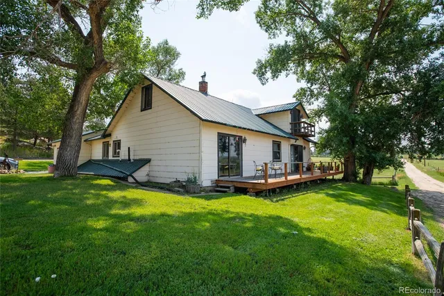 a view of a house with a yard and sitting area