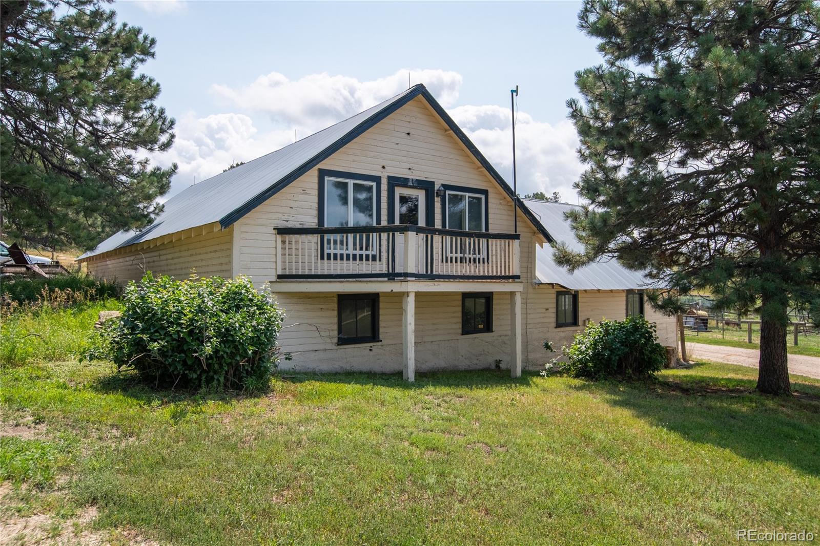 11503 East Smith Road Elbert, CO 80106 - Photo 23 of 44 a front view of a house with a garden