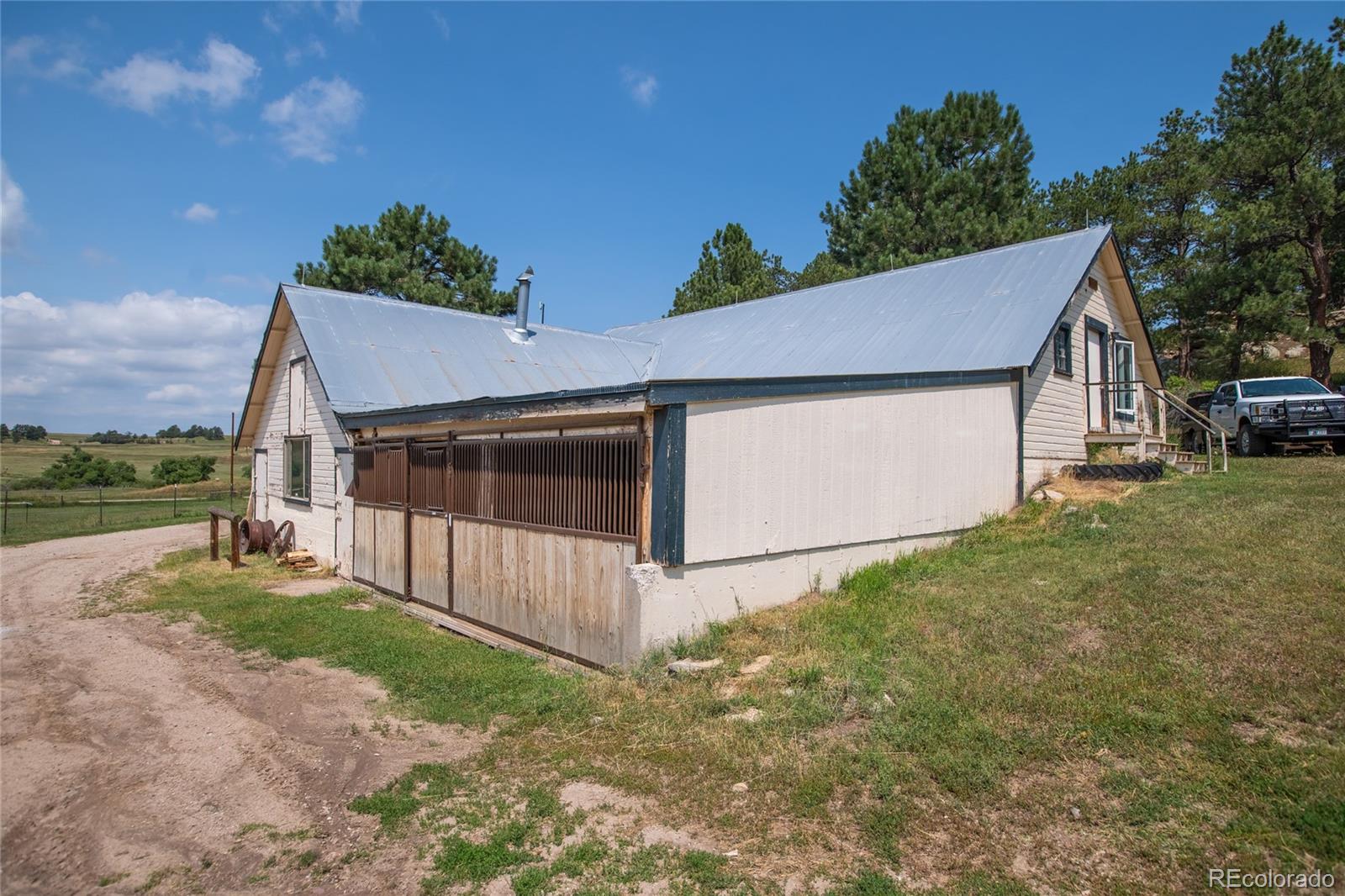 11503 East Smith Road Elbert, CO 80106 - Photo 24 of 44 a view of a house with a yard and garage