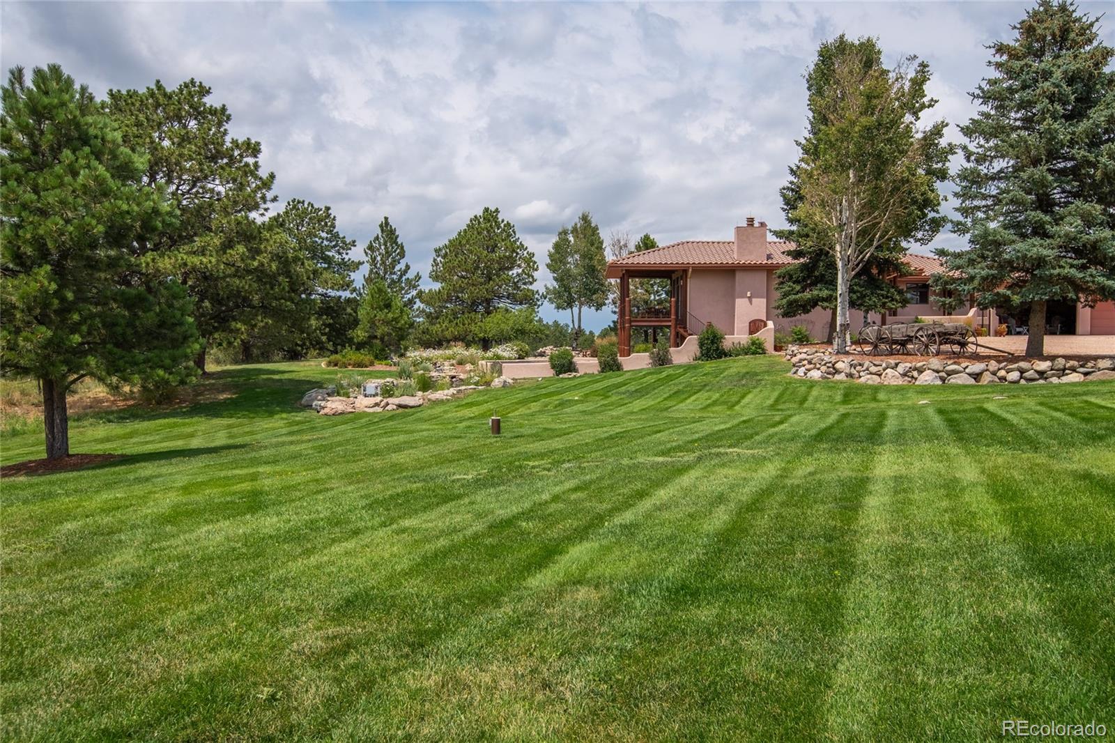 11503 East Smith Road Elbert, CO 80106 - Photo 27 of 44 a backyard of a house with table and chairs