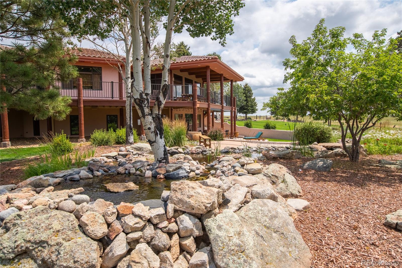 11503 East Smith Road Elbert, CO 80106 - Photo 33 of 44 a front view of a house with garden
