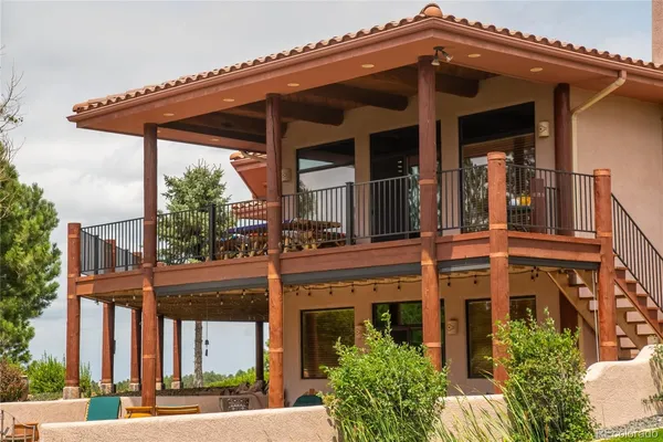 a view of a house with swimming pool and sitting area
