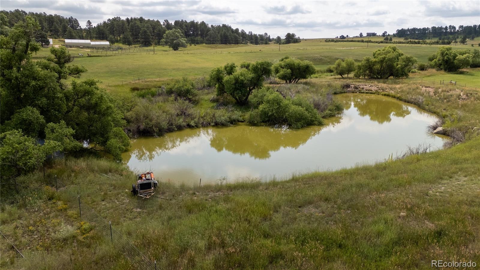 11503 East Smith Road Elbert, CO 80106 - Photo 7 of 44 a view of a lake in middle of a town with houses