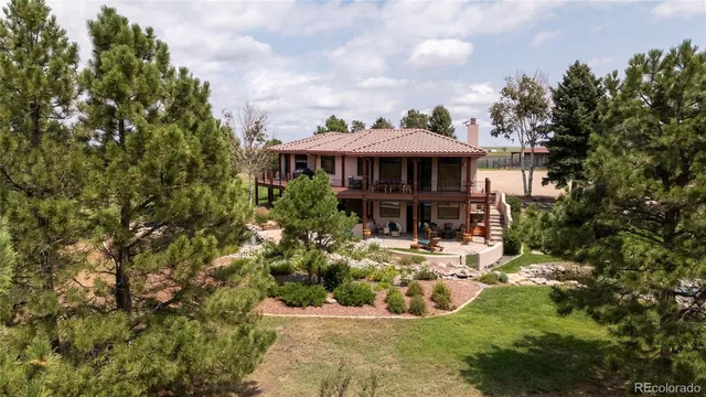 a view of a house with yard and sitting area
